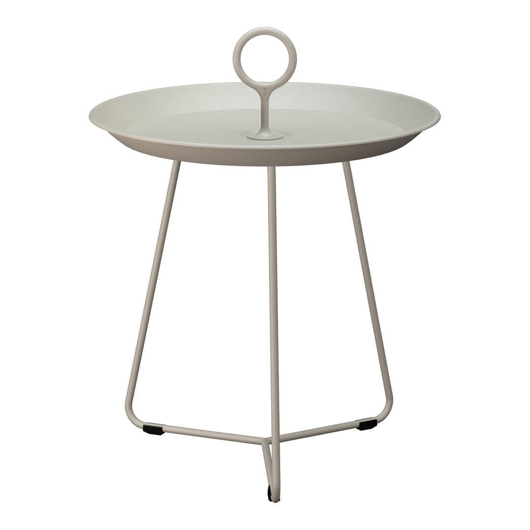 Round light gray tray table with a minimalist design and a circular handle, set on sleek white legs.