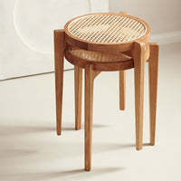 Wooden nesting stools with natural cane patterns and warm oak finish, ideal for a minimalist home decor.