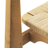Natural wood tones with textured beige woven seat, showcasing a simple, modern design.