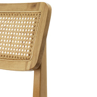 Natural bamboo chair with a woven rattan backrest in a light, earthy color palette and intricate pattern design.