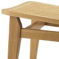 Light oak stool with a woven cane seat, showcasing a natural wood finish and textured pattern.