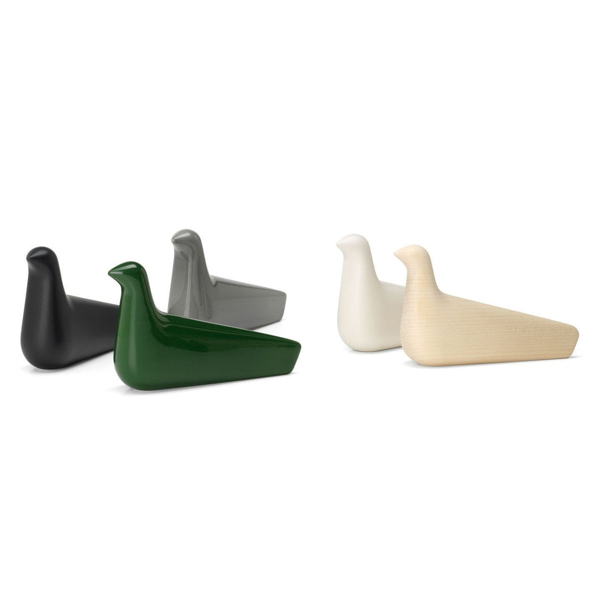 Four decorative bird figurines in black, green, gray, and white with smooth, minimalist designs.
