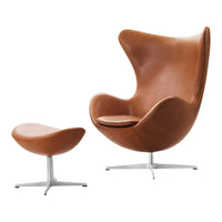 Brown leather lounge chair and ottoman with smooth, modern curves and sleek silver metal bases.