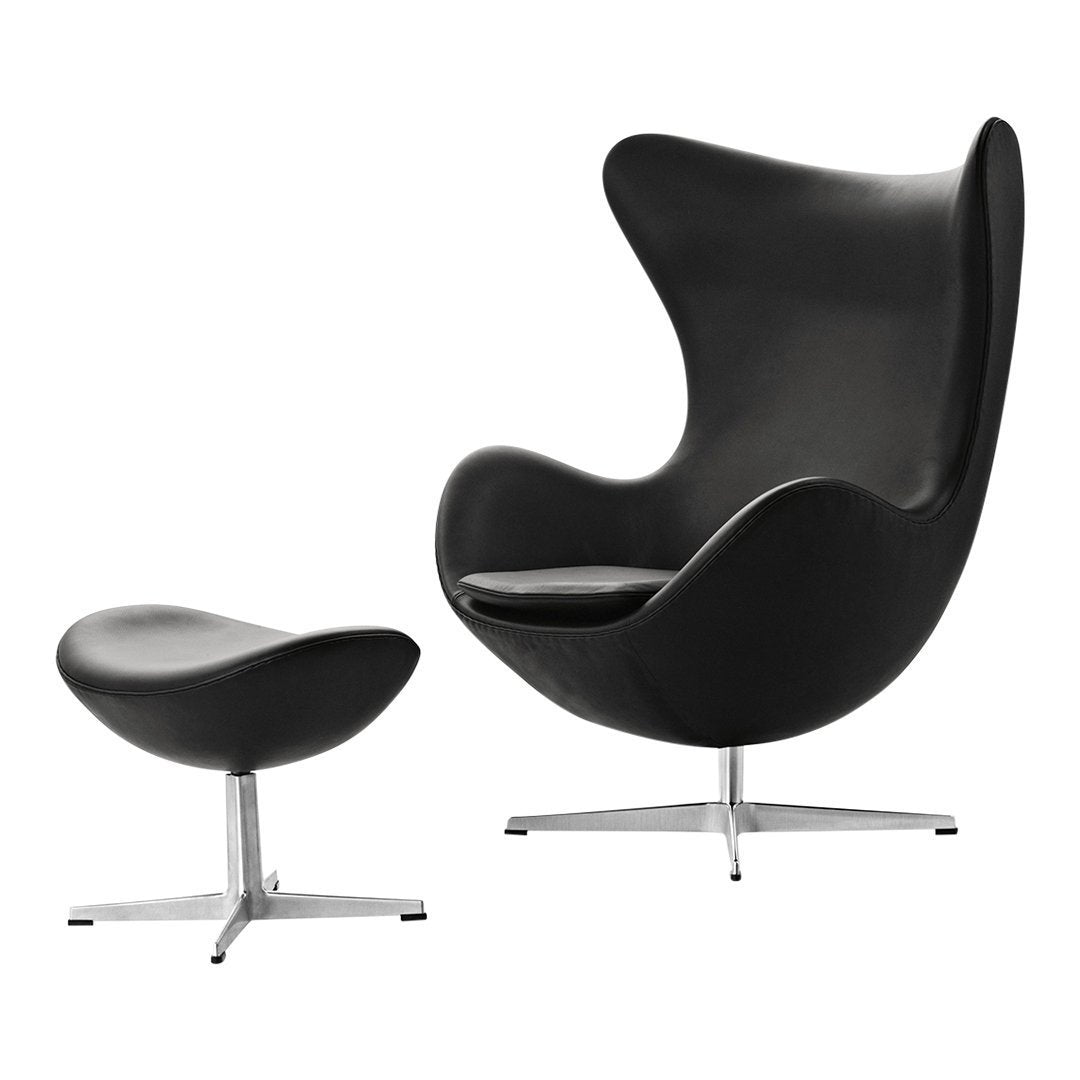 Modern black egg chair and matching ottoman with smooth, sleek surfaces and minimalist design. Ideal for contemporary decor.