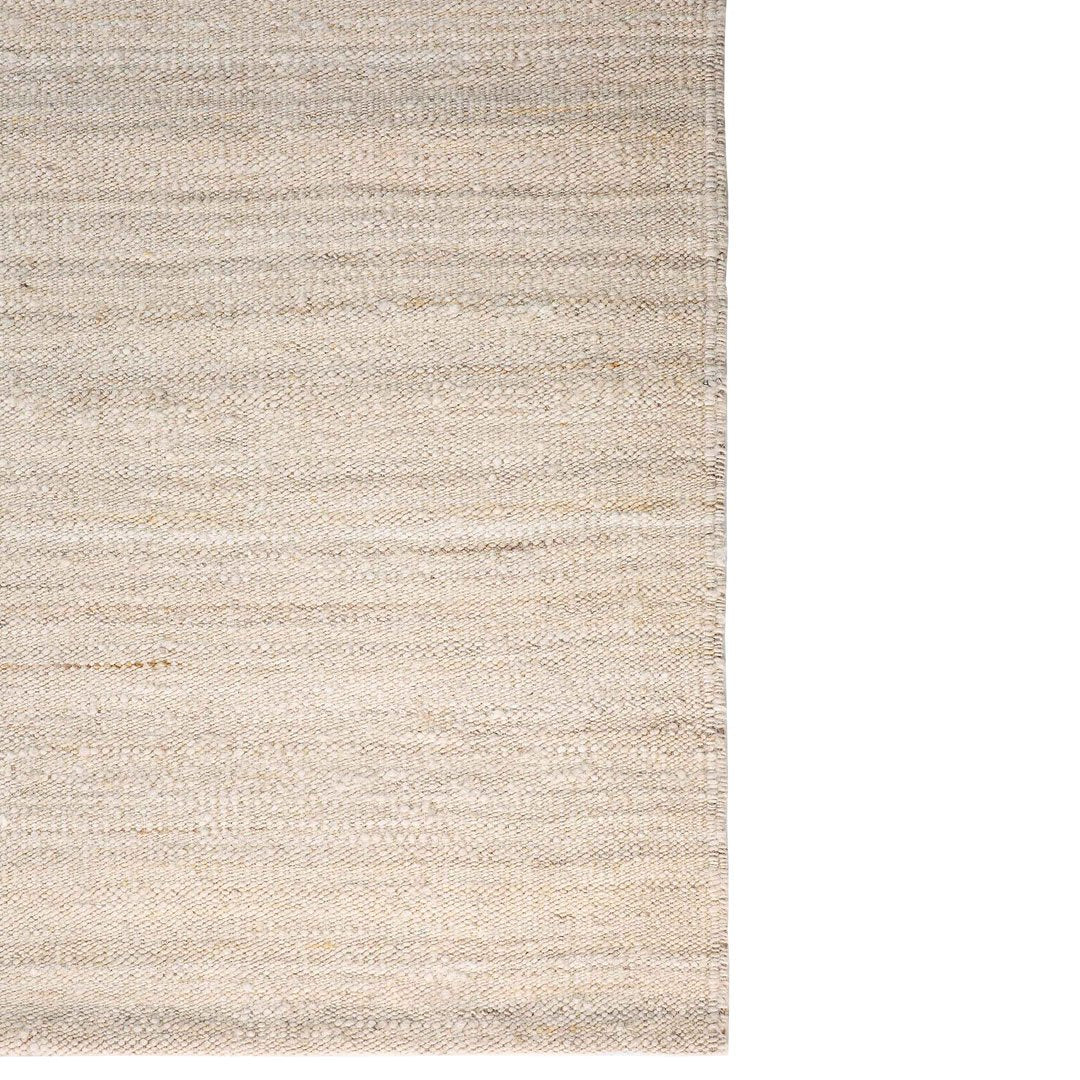 Neutral beige area rug with subtle textured stripes, perfect for modern and minimalistic interiors.