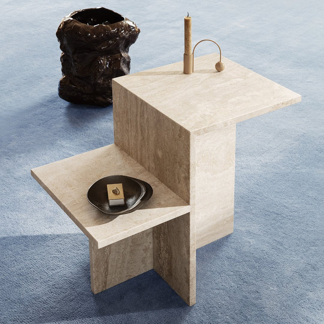 Sand-colored geometric side table on a soft blue carpet, featuring clean lines and minimalistic design.
