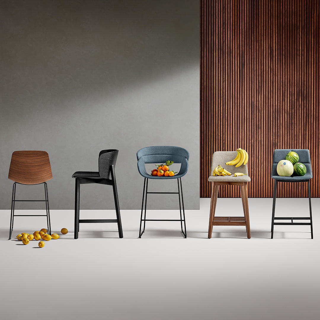 Set of five modern bar stools in wood, black, grey, blue, and beige against a sleek backdrop with textured wood paneling.