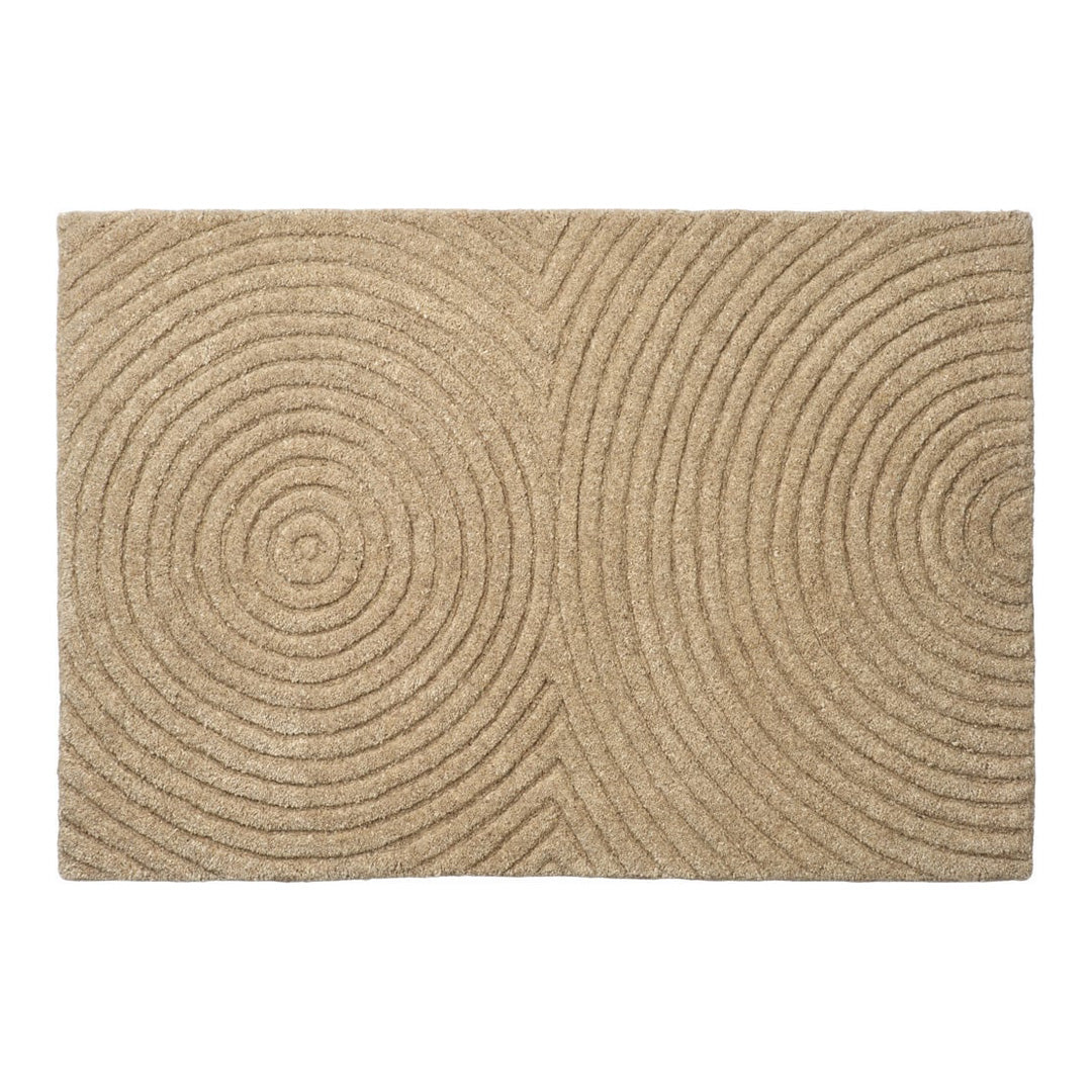 Beige area rug with circular patterns, featuring textured grooves and a modern design for stylish interiors.