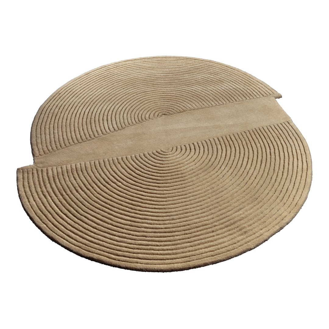 Beige circular area rug featuring a modern cut-out design with concentric texture patterns.