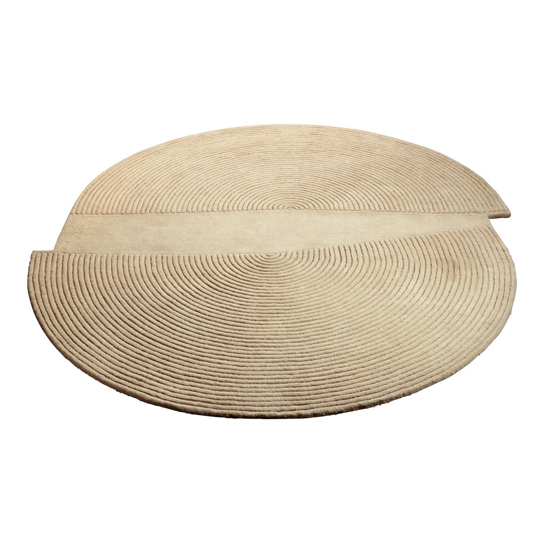 Beige round area rug with a textured spiral pattern, featuring two intersecting arcs for a modern touch.