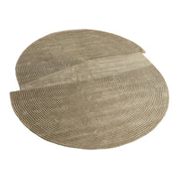 Beige circular rug with textured, concentric lines creating a modern, woven pattern. Ideal for stylish home decor.