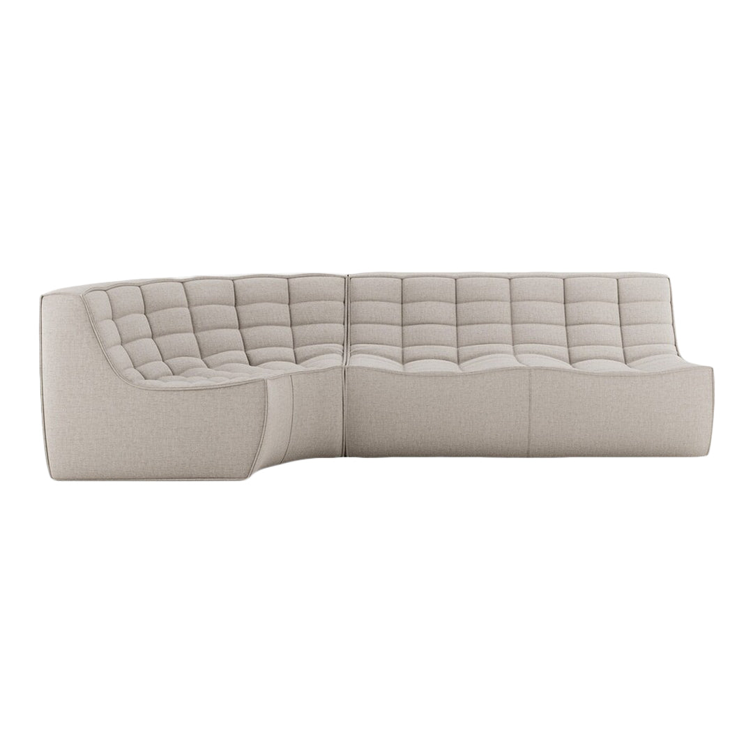 Light beige sectional sofa with a quilted fabric pattern, featuring a modern design and curved silhouette.