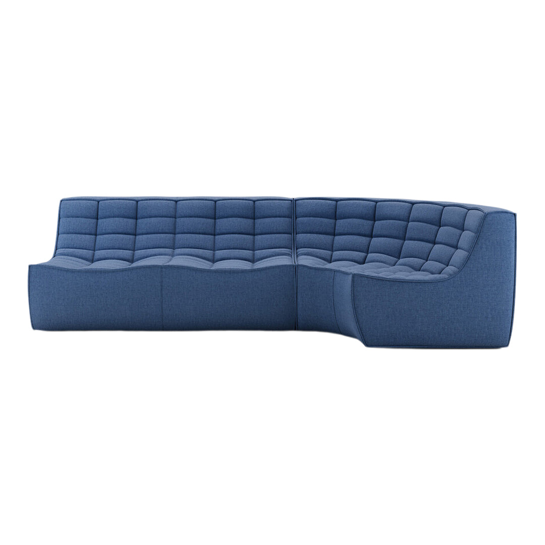 Blue upholstered sectional sofa with a tufted pattern and smooth curves, perfect for modern living spaces.