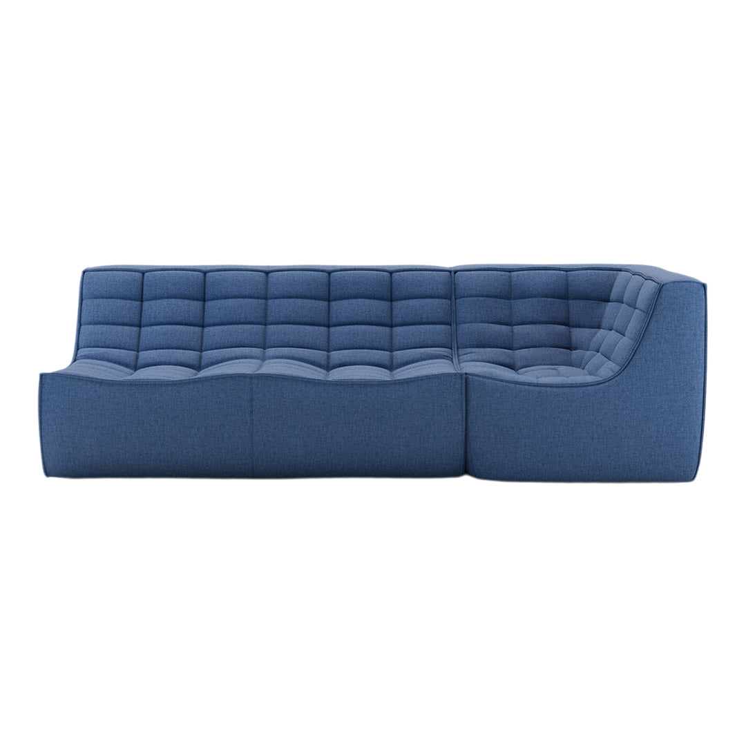 Blue upholstered sofa with tufted texture and smooth contours, enhancing modern decor aesthetics.
