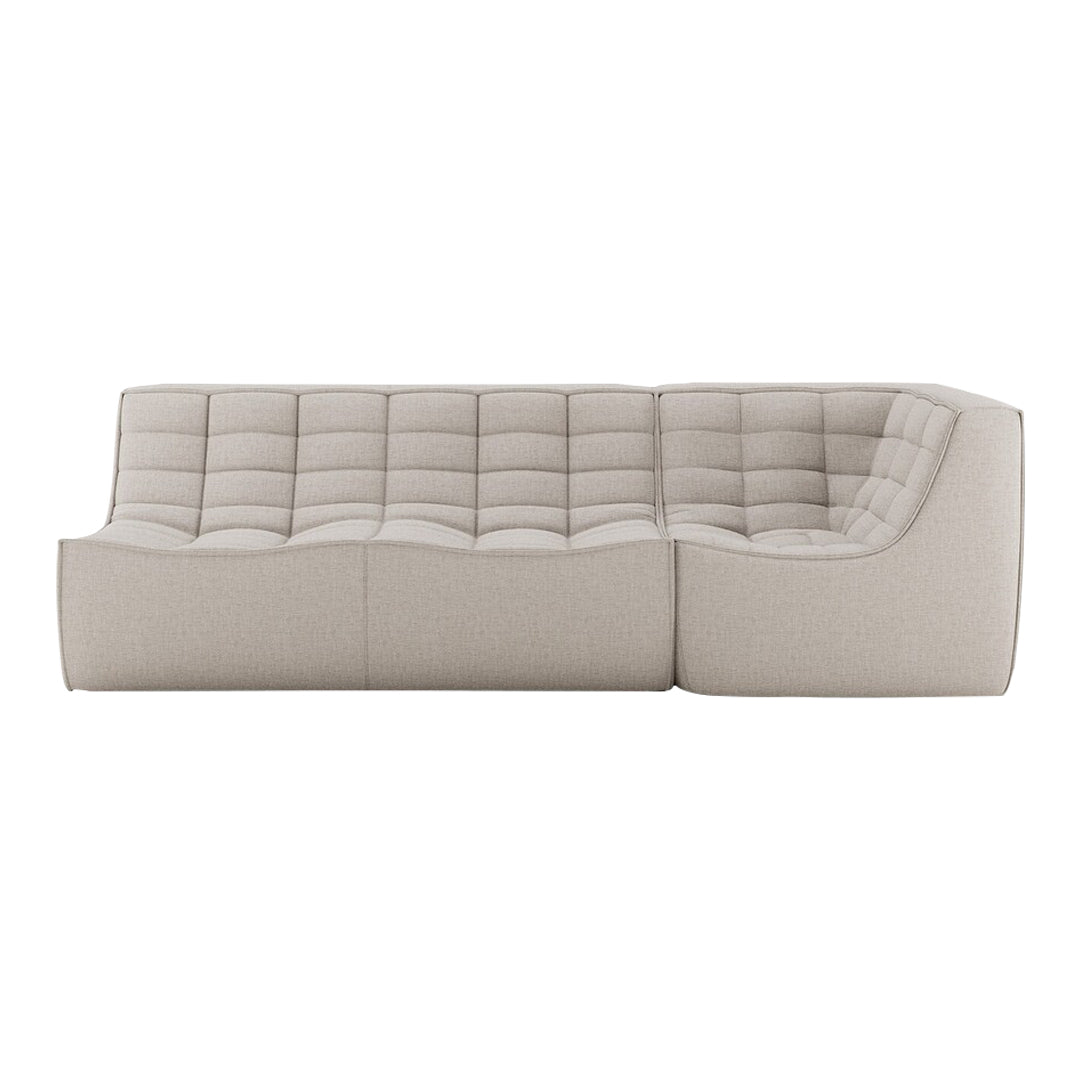 Beige tufted sectional sofa showcasing a modern, minimalist design with soft fabric texture and neutral tones.
