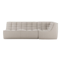 Beige tufted sectional sofa showcasing a modern, minimalist design with soft fabric texture and neutral tones.