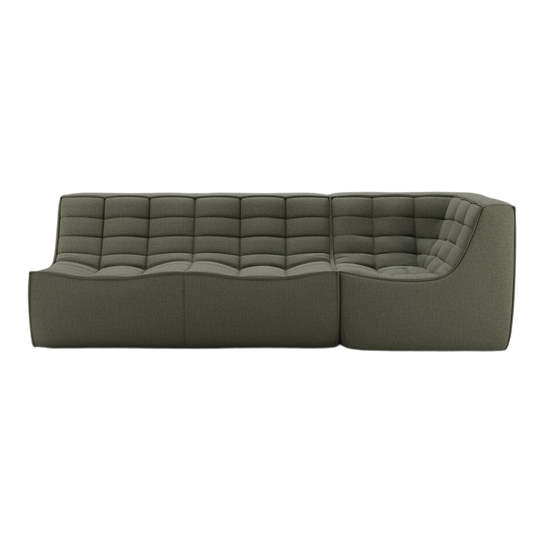 Green upholstered sectional sofa with tufted design and smooth contours. Elegant, modern style for contemporary spaces.