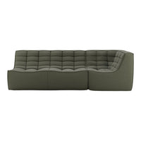 Green upholstered sectional sofa with tufted design and smooth contours. Elegant, modern style for contemporary spaces.