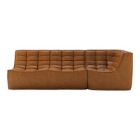 Brown tufted sectional sofa with a smooth, curved design and a modern, minimalist aesthetic.