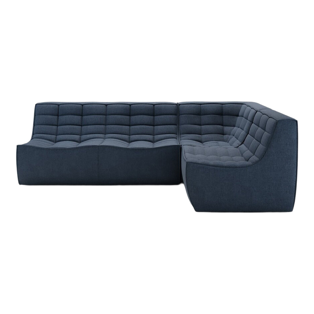 Dark blue upholstered sectional sofa with a tufted pattern and sleek design for modern interiors.