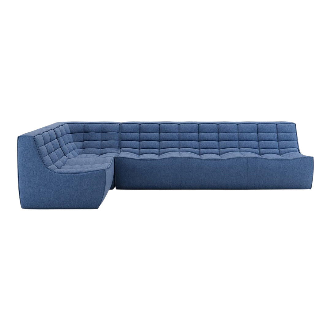 Blue sectional sofa with tufted fabric, showcasing a modern design and varying shades of blue throughout.