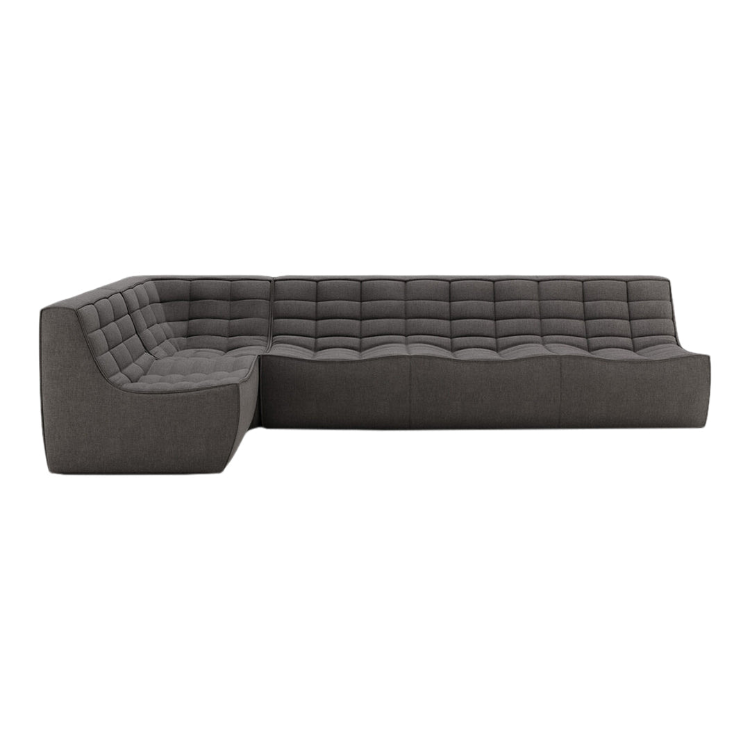 Modern dark gray sectional sofa with a sleek tufted pattern for contemporary living spaces.