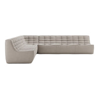 Modern sectional sofa in soft beige fabric with tufted cushion pattern and clean lines, perfect for contemporary decor.