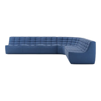 Blue tufted sectional sofa with a modern design and textured fabric, featuring varying shades of deep navy and soft azure.