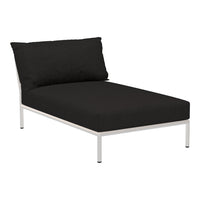 Black lounge chair with a sleek white metal frame and a stylish, minimalist design. Perfect for modern spaces.