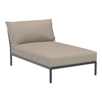 Modern light gray chaise lounge with soft, textured cushions and a sleek black metal frame. Ideal for outdoor relaxation.