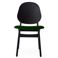 Black chair with green velvet seat, featuring a minimalistic design and smooth finish. Perfect for modern interiors.