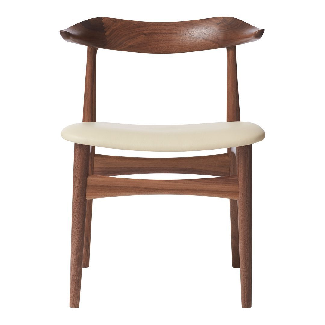 Mid-century modern chair in rich walnut finish with a cream upholstered seat for a stylish contrast.