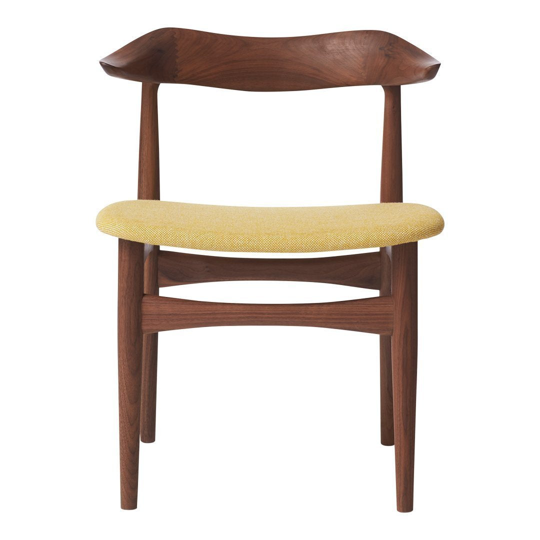 Mid-century style chair in rich walnut wood with a solid yellow woven seat cushion. Elegant and modern design.