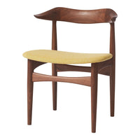Mid-century chair with a rich walnut frame and a textured yellow seat cushion.