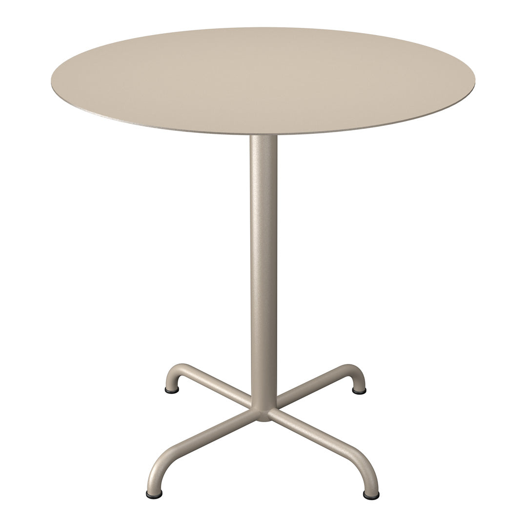 Round beige table with a sleek, minimalist design and a smooth surface, complemented by a sturdy, four-legged base.