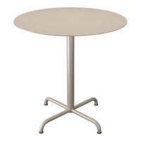 Round beige table with a sleek, minimalist design and a smooth surface, complemented by a sturdy, four-legged base.