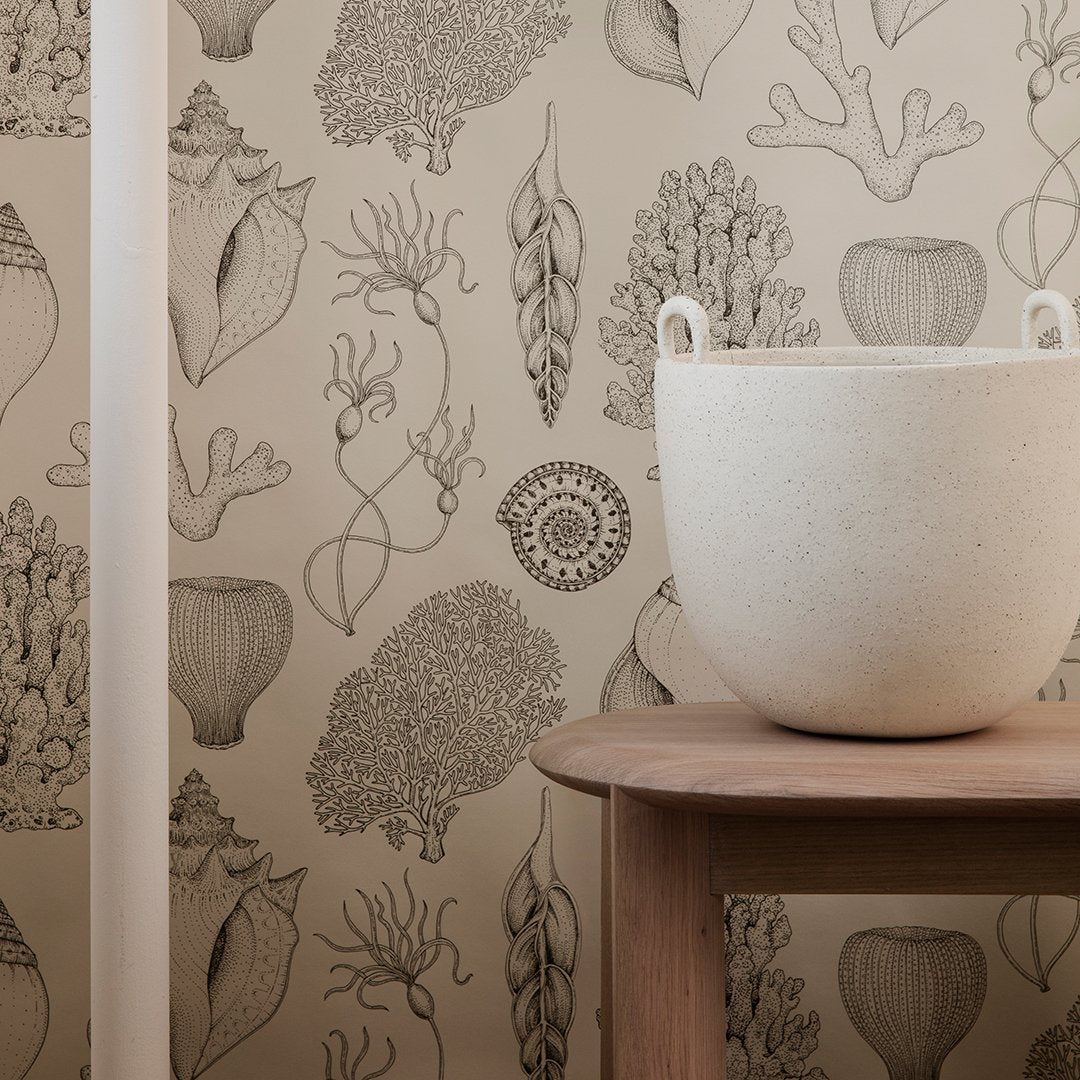 Neutral-toned wallpaper featuring intricate botanical and coral sketches in soft brown and beige patterns.