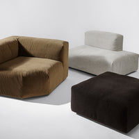 "Modern upholstered furniture set in earthy brown, soft grey, and deep black hues with minimalist design."