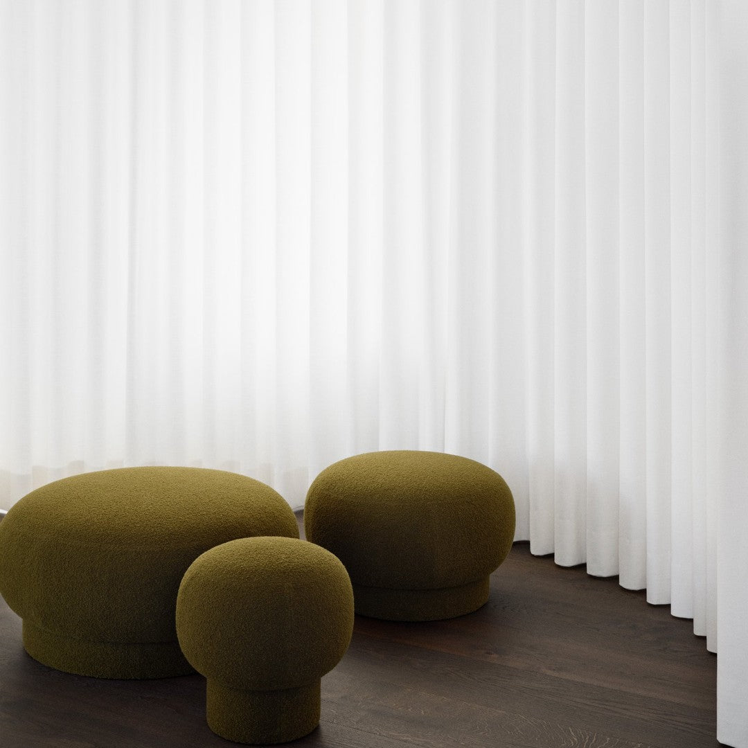 Olive green rounded furniture pieces against white vertical curtains, featuring a modern minimalist design.