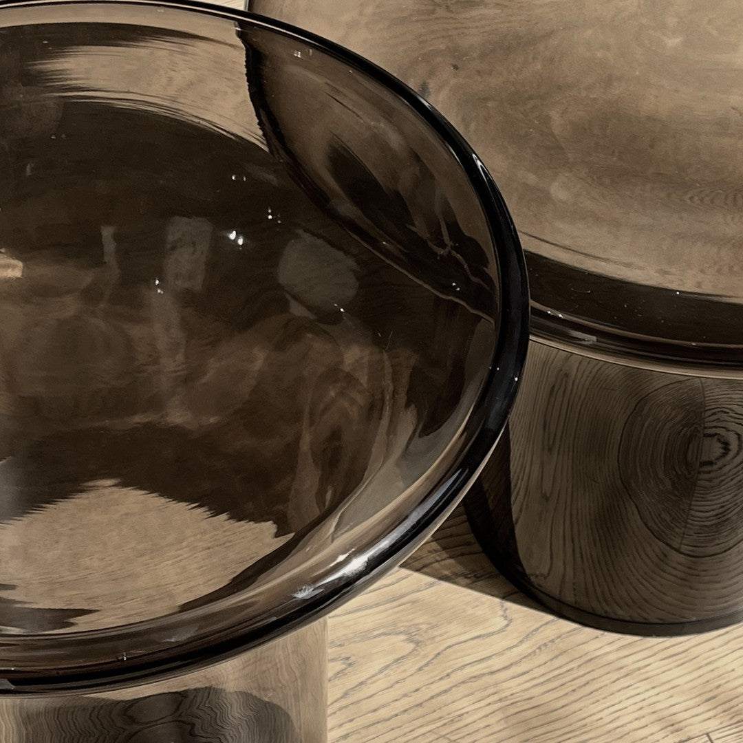 Brown tinted glass bowls with smooth, glossy patterns, featuring rounded edges and a sleek finish.