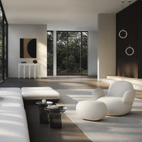 Modern living room featuring neutral tones, geometric patterns, and dark wood accents, with white and light gray furnishings.