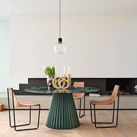 Elegant green and black marble dining table, paired with modern tan and black chairs, set against a minimalist backdrop.