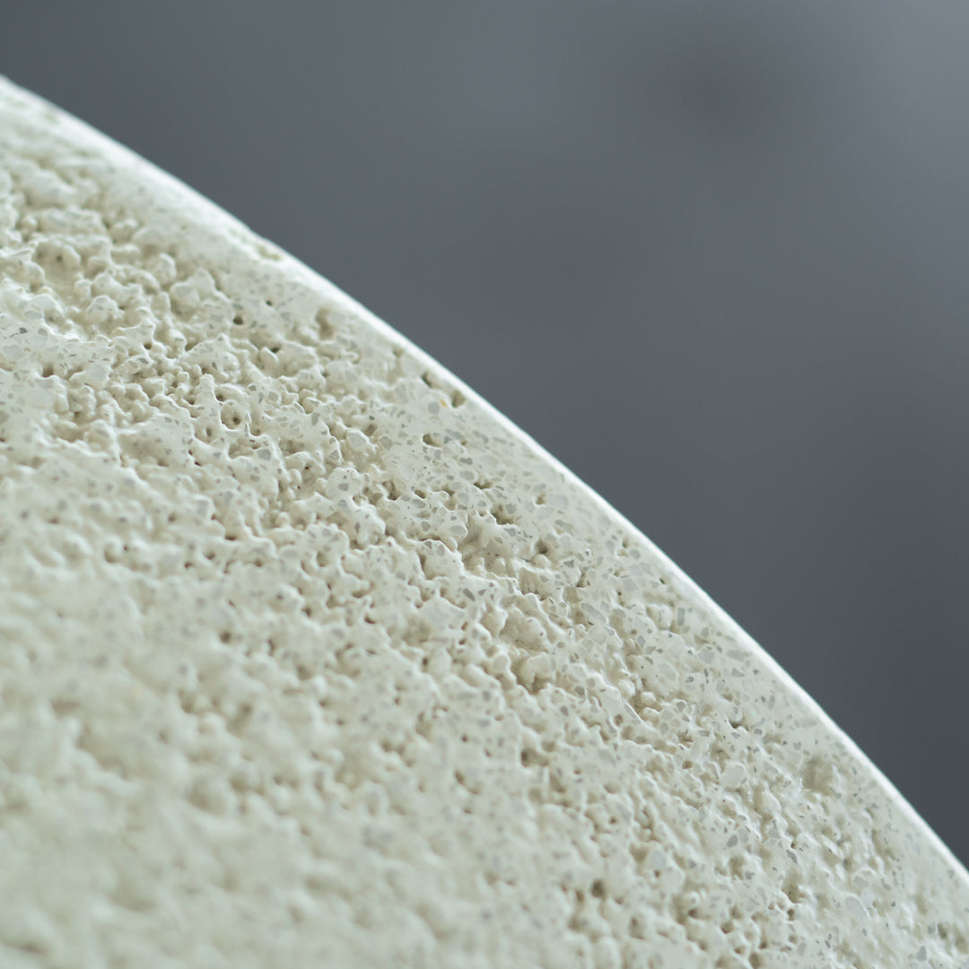 Textured light green surface with a subtle, organic pattern against a soft gray background. Ideal for decor.