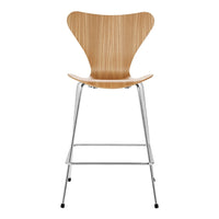 Wooden chair with a natural light wood finish and sleek chrome legs, featuring a smooth, modern design.