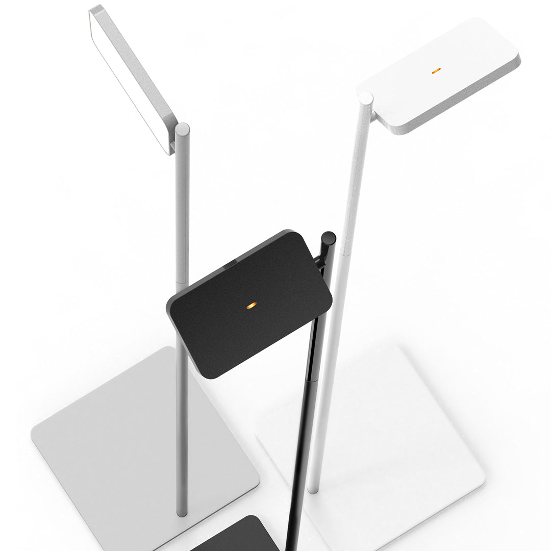 Modern floor lamps in sleek black and white with minimalistic designs and subtle orange accents.