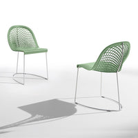 Two mint green chairs with a mesh pattern and sleek metal legs, casting soft shadows on a white background.