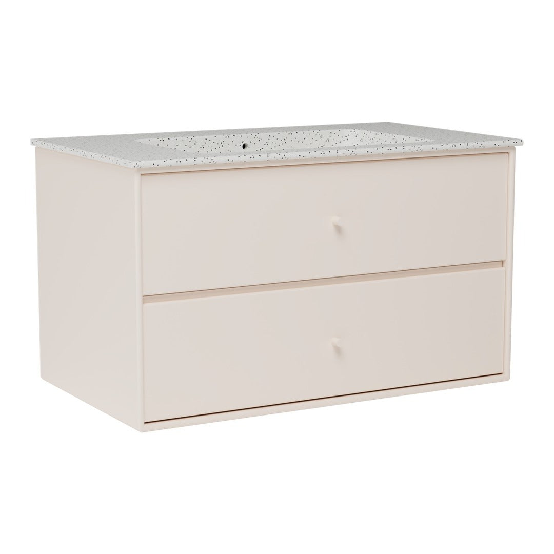 Light pink dresser with a speckled white countertop and smooth surface. Two spacious drawers for storage.