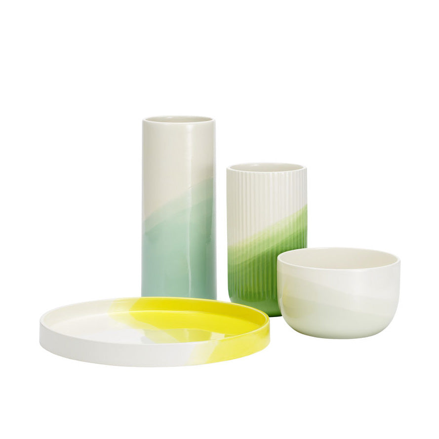 Colorful ceramics featuring gradient green and yellow patterns in modern designs. Perfect for home decor.