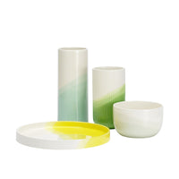 Colorful ceramics featuring gradient green and yellow patterns in modern designs. Perfect for home decor.