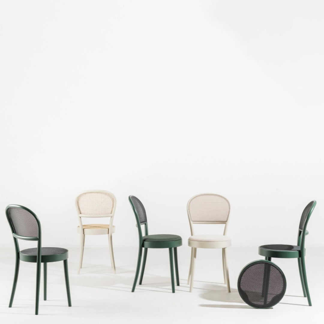 "Set of five chairs in green, beige, and black, featuring sleek lines and mesh patterns."